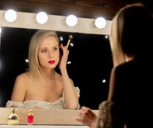 Beautiful blonde woman near makeup mirror. Envato Masson-Simon